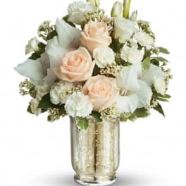 Peach roses and white flowers in a gold glass vase