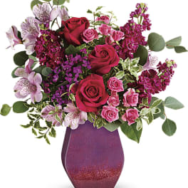 Pink and red rose bouquet in a glittery purple vase