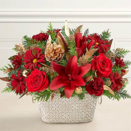 Red floral arrangement in a patterned white container