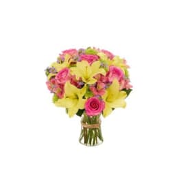 Bouquet of pink roses and yellow lilies in a glass vase
