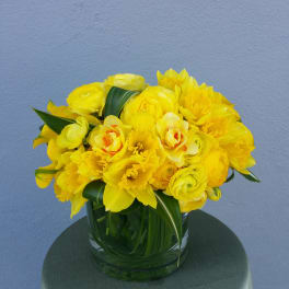 Yellow floral bouquet in a clear glass vase