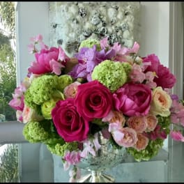 Pink and green floral arrangement in a glass vase