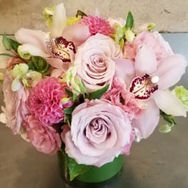 Pink and lavender bouquet in a green vase