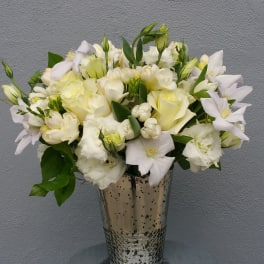 White floral arrangement in a silver vase