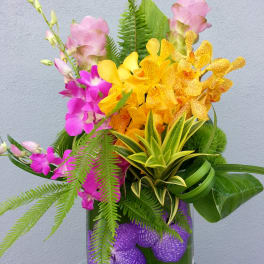 Colorful orchid arrangement in a glass vase