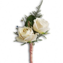 White rose boutonniere with greenery and a pink-wrapped stem