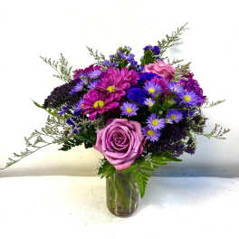 Purple and pink mixed bouquet in a glass vase
