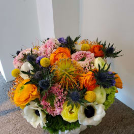 Colorful mixed bouquet with orange, pink, white, and yellow blooms