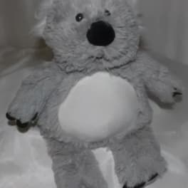 Gray plush teddy bear with a white belly and black nose