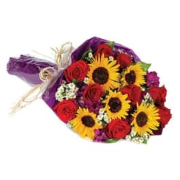 Bouquet of red roses and yellow sunflowers wrapped in purple paper