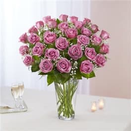 Pink roses arranged in a clear glass vase