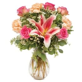 Bouquet of pink roses and lilies in a clear glass vase