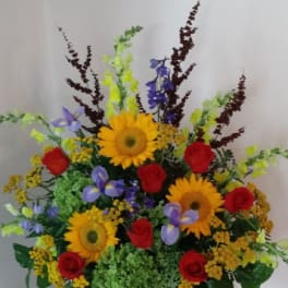 Colorful mixed flower arrangement with sunflowers and red roses