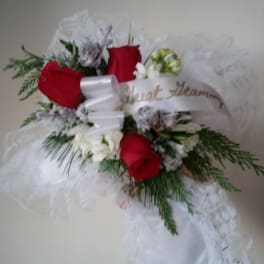 Red roses and white flowers with a white ribbon and tulle