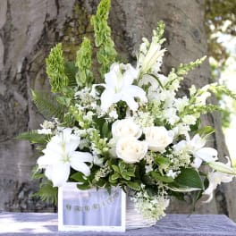White lilies and roses in a basket with a "Married" sign
