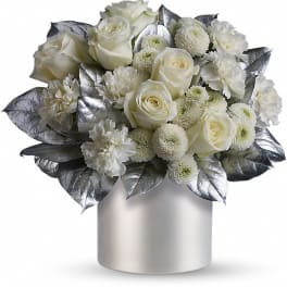 White roses and carnations in a silver vase
