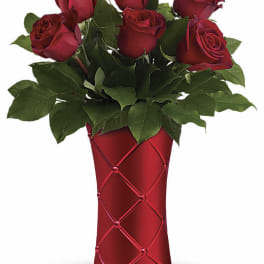 Red roses arranged in a red vase