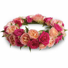 Pink and peach rose floral wreath on a white background