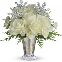 White roses in a silver vase with glittery silver accents