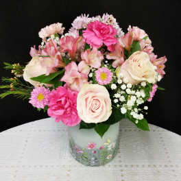 Pink and white mixed flower arrangement in a decorative vase