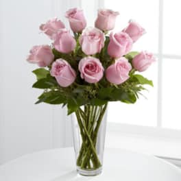 Pink roses arranged in a clear glass vase