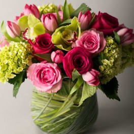 Pink roses and tulips in a glass vase