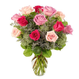 Bouquet of pink and red roses in a clear glass vase