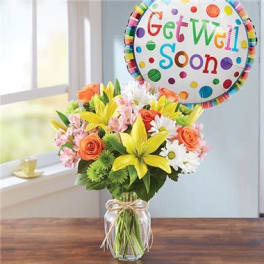 Colorful bouquet in a glass vase with a "Get Well Soon" balloon