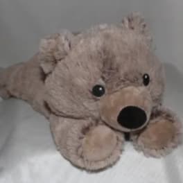 Plush teddy bear lying on a bed