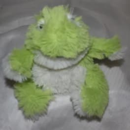 Green and white plush frog toy with fuzzy texture