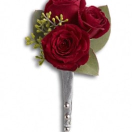 Three red rose boutonniere with silver pin stem