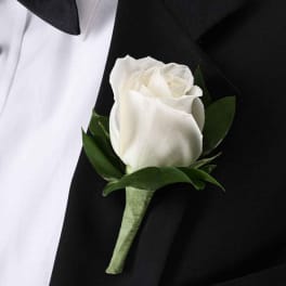 White rose boutonniere on a black suit jacket
