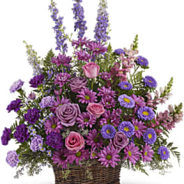 Basket arrangement of purple and pink flowers with tall spikes