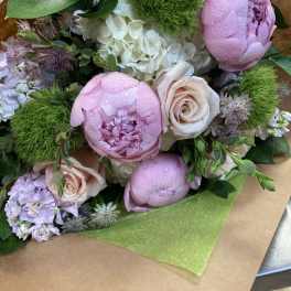 Bouquet of pink peonies, pale roses, and white hydrangea