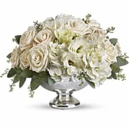 White rose arrangement in a silver pedestal bowl