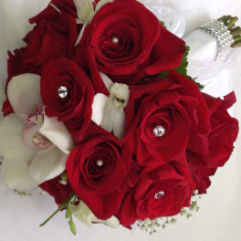 Hand-tied bouquet of red roses with white orchids and rhinestone accents