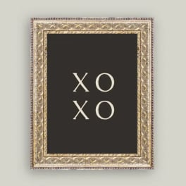 Framed black sign with the words XO XO in white letters