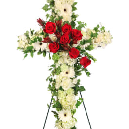 Cross-shaped floral standing spray with red roses and white blooms