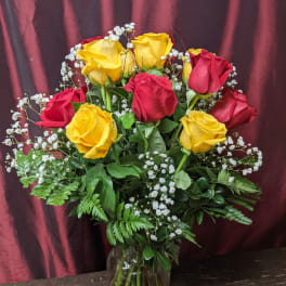 Bouquet of red and yellow roses in a glass vase