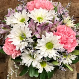 Bouquet of white daisies, pink carnations, and lavender flowers