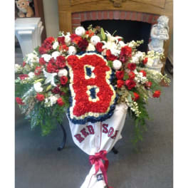 Large floral tribute with a red "B" and Red Sox banner