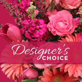 Pink floral arrangement with roses and daisies labeled Designer's Choice