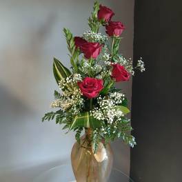 Tall vase arrangement of red roses with white baby's breath