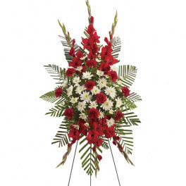Standing floral spray with red and white flowers on an easel