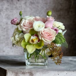 Pink and white bouquet in a clear glass vase
