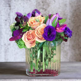 Pink and purple bouquet in a clear glass vase