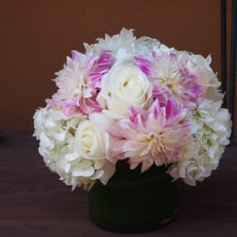 White and pink flower arrangement in a dark vase
