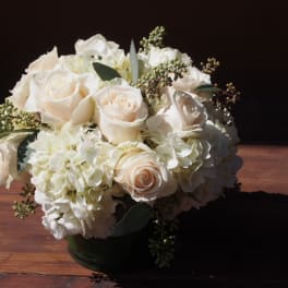White rose and hydrangea bouquet in a dark vase