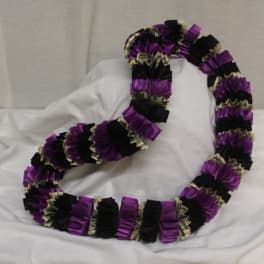 Purple and black ribbon lei draped in a loop