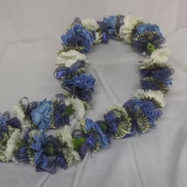 Blue and white flower lei on a light fabric background